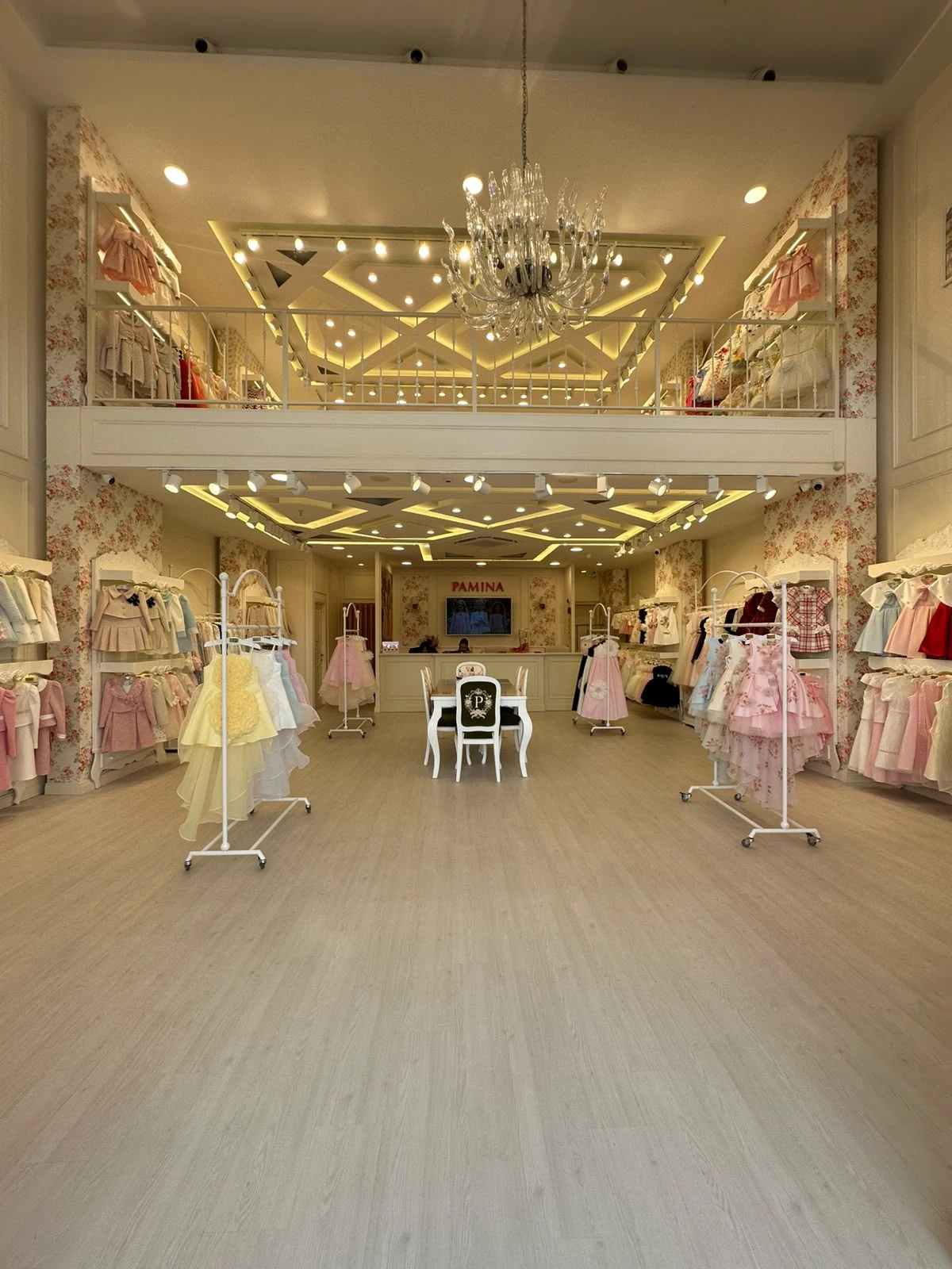 Inside Pamina Merter showroom with collections displayed around the chandelier-lit space