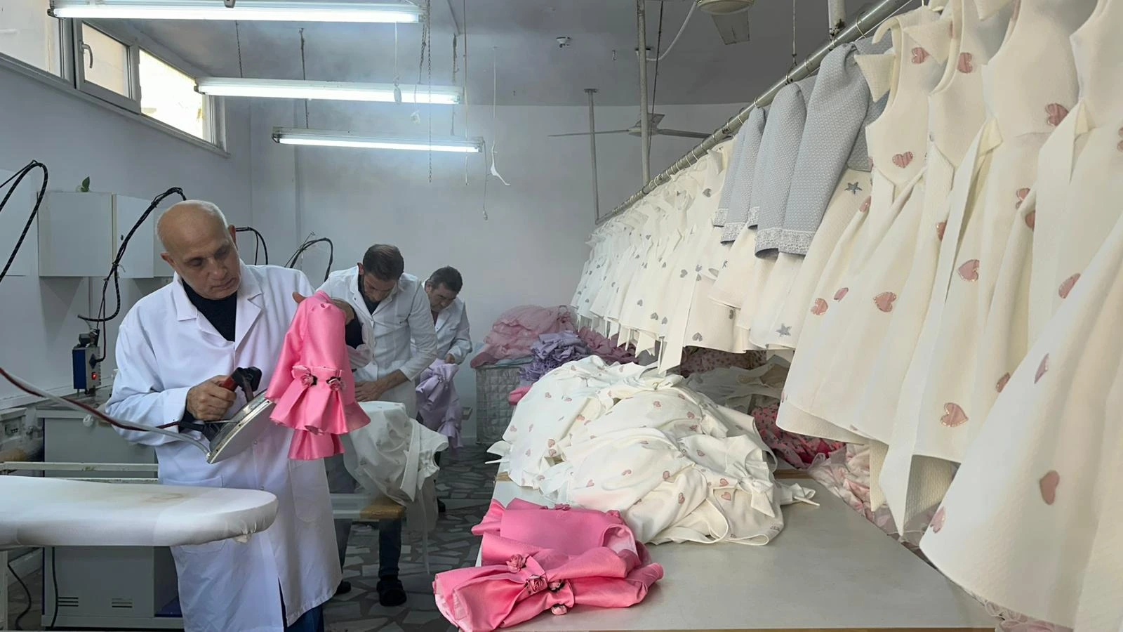 Pamina team pressing garments in the production workshop